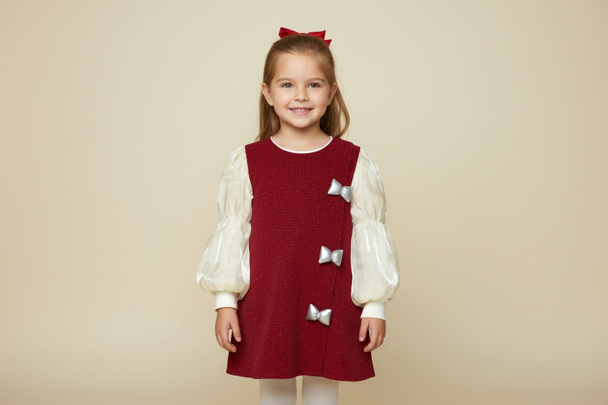 Red dress with white long-sleeve layers and silver bows on a white background